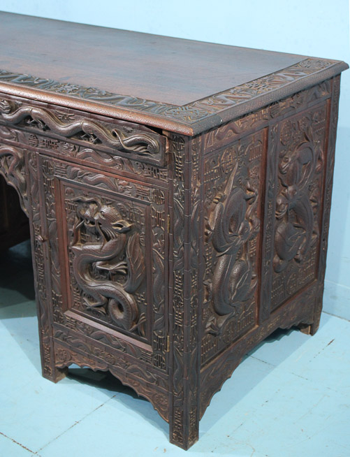 044b - Heavily carved walnut Oriental desk with dragons