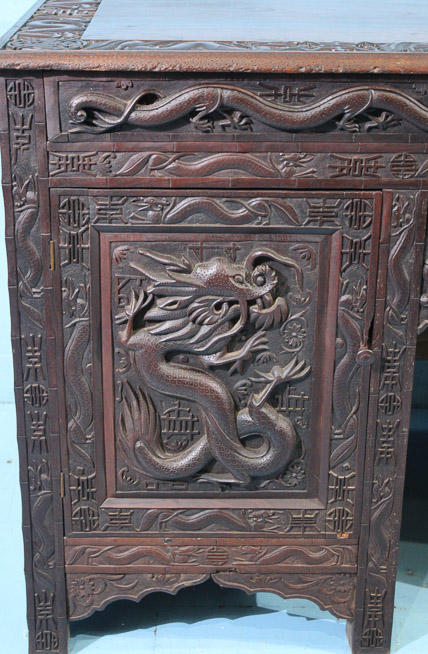 044c - Heavily carved walnut Oriental desk with dragons